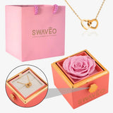 Senvoa pink gift bag, pink box with pink rose, and gold heart necklace engraved with names.
