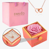 Senvoa pink gift bag, pink box with pink rose, and rose gold heart necklace engraved with names.