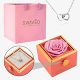 Senvoa pink gift bag, pink box with pink rose, and silver heart necklace engraved with names.