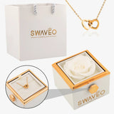 Senvoa white gift bag, white box with white rose, and gold heart necklace engraved with names.