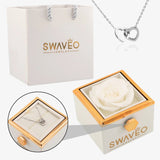 Senvoa white gift bag, white box with white rose, and silver heart necklace engraved with names.