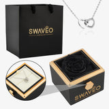 Senvoa black gift bag, black box with black rose, and silver heart necklace engraved with names.