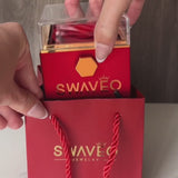 Video clip showing a red preserved rose box being lifted from a red Senvoa gift bag, revealing a red preserved rose, then rotated open to display a gold double-heart necklace inside, and ending with the necklace being worn on a woman’s neck.